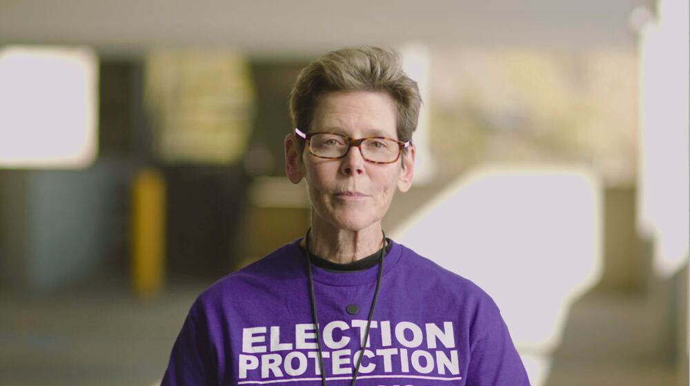 Volunteer in an Election Protection shirt speaking to camera